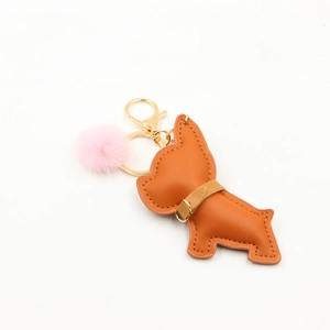 Detail of brown PU leather French Bulldog keychain with pink fur pompom and gold clip