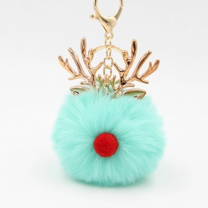 Detailed close-up of mint green plush ball reindeer keychain with gold antlers