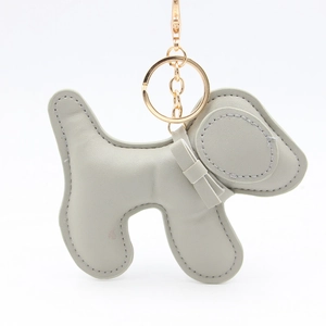 Detail of grey PU leather puppy keychain with neat stitching and a cute bow tie accent