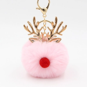Close-up of pink fluffy pom-pom keychain with gold reindeer antlers and lobster clasp