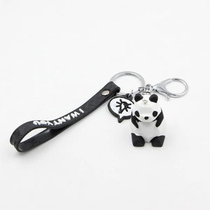 Cute resin panda keychain with black 3D facet doll and rubber wrist strap on white background