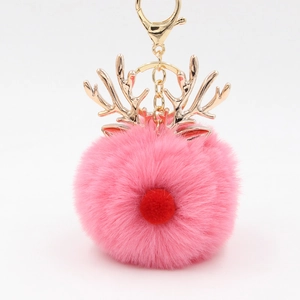 Detailed view of pink plush reindeer keychain with fluffy fur and gold hardware