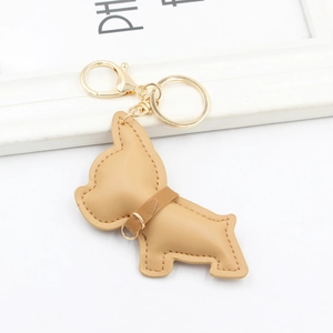 Detail of cute PU leather French Bulldog keychain with golden clasp and fine stitching