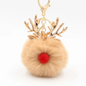 Detailed close-up of Christmas reindeer pompom keychain with golden antlers and red nose