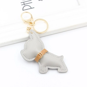 Detail of grey leather French Bulldog keychain with white stitching and gold hardware