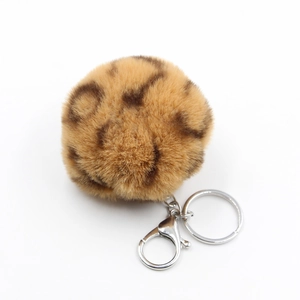 Detailed view of 8cm leopard print plush ball keychain with silver metal lobster clasp