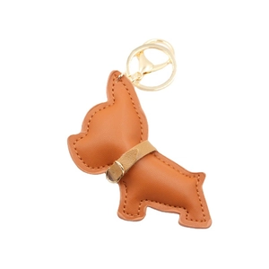 Cute brown leather French Bulldog keychain with gold metal ring on a white background