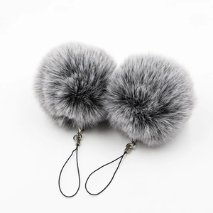 Pair of fluffy grey faux fur ball keychains with black lanyards and metal rings