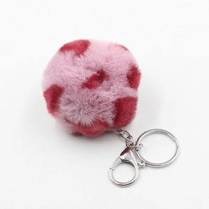 Macro shot of 8cm leopard print faux fur pompom keychain with silver metal lobster clasp