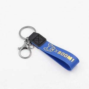 Lanière de porte-clés en cuir bleu avec texte XBOOM doré et icône de bouledogue