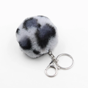 Detailed view of 8cm leopard print faux fur pompom keychain with silver metal lobster clasp