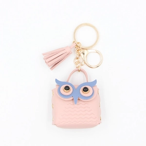 Close-up of pink PU leather owl coin purse with gold lobster clasp and tassel charm