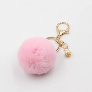Pink plush ball keychain with a golden lobster clasp and white pearl pendant charm