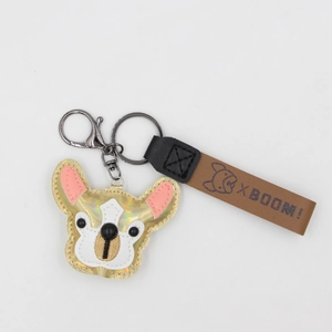 Detail of laser-effect PU leather French Bulldog keychain with gold stitching and metal clasp