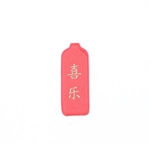 Macro shot of red faux leather keychain tag with gold Joy Chinese character text