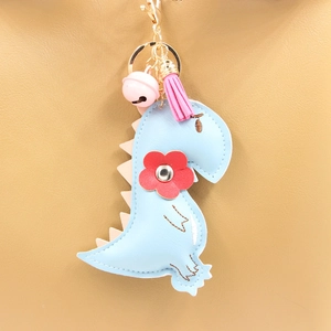 Cute light blue PU leather dinosaur keychain with pink tassel and bell on bag
