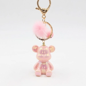 Pink electroplated iridescent bear keychain with a matching fluffy mink fur pom pom