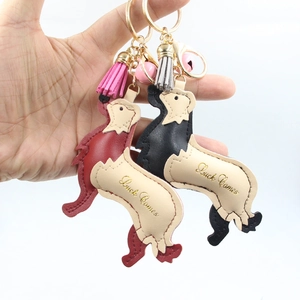 Cute leather golden retriever dog keychain with bell and tassel in red and black