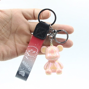 Pink holographic cartoon bear keychain with gradient woven wristlet strap and hook