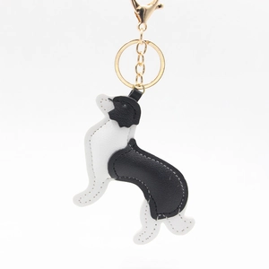 Detail of Border Collie leather keychain with gold hardware and white stitching