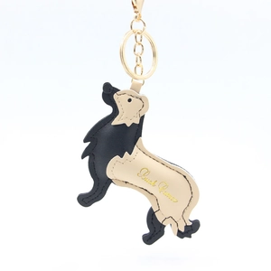 Detail of a Golden Retriever leather keychain with gold ring and Quick Games print