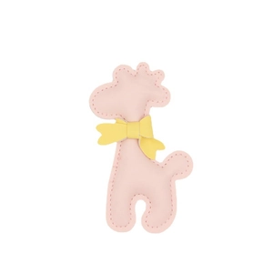 Close-up of pink leather giraffe charm with yellow bow and detailed stitching detail