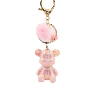 Pink pearlescent bear keychain with soft pompom and elegant gold-tone metal clasp