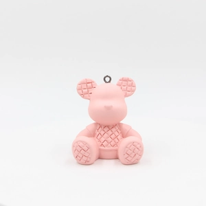 Detailed view of a pink resin bear charm featuring a classic woven texture and silver ring