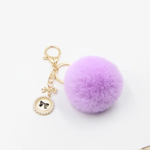 Purple fluffy pom pom keychain with gold bow and pearl perfume bottle charm accessory