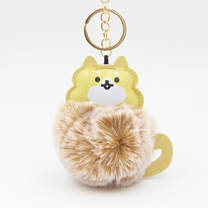 Cute brown pom-pom keychain with yellow leather dog head and golden metal keyring clasp