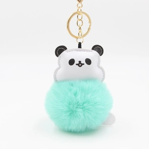 Detail of cartoon panda pendant with mint green fluffy pompom and gold metal ring