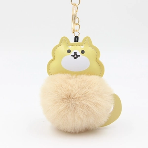 Detail of Shiba Inu plush keychain with faux fur pompom and golden metal ring