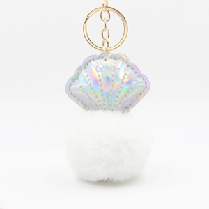 Detail of laser PU shell pendant with fluffy pom-pom and gold metal keychain loop