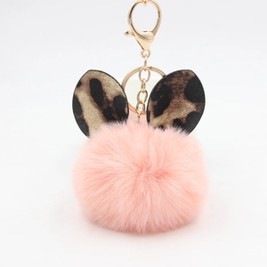 Pink plush ball keychain with leopard print ears and gold lobster clasp for bags