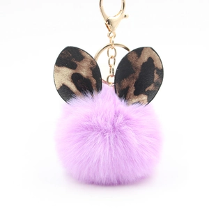 Purple plush pom pom keychain with leopard print bunny ears and gold lobster clasp