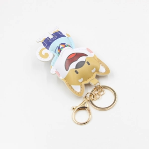 Cartoon dog keychain with blue outfit and gold lobster clasp on white background