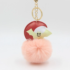 Pink faux fur pompom keychain with a cute bat character and a gold metal clip