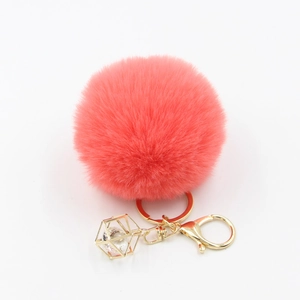 Pink plush faux fur ball keychain with golden geometric crystal charm for handbags
