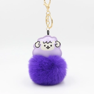 Details des lila Cartoon Schaf Lederanhängers mit flauschigem Kunstfellbommel und Goldhaken