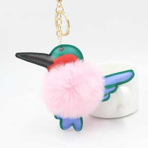 Cartoon hummingbird keychain with pink fluffy fur ball and colorful leather details
