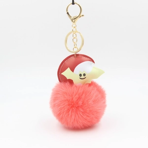 Pink faux fur pompom Halloween keychain with a yellow bat and golden metal clip