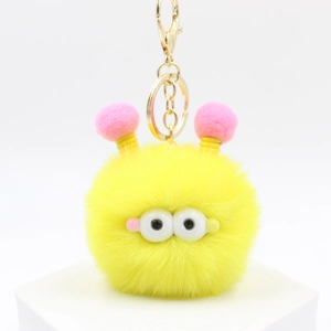 Simpatico portachiavi mostro di peluche giallo con grandi occhi e antenne rosa