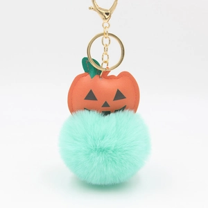 Halloween pumpkin keychain with orange leather Jack-o'-lantern and mint green pompom