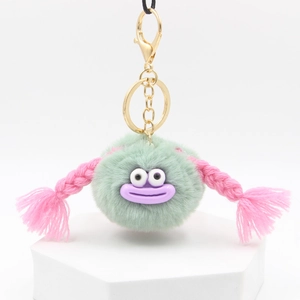 Cute mint green plush monster keychain with pink braids and golden lobster clasp