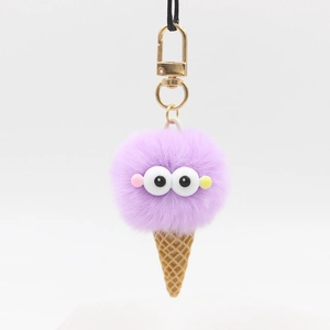 Cute ice cream plush keychain with fluffy purple pompom and cartoon eyes on a waffle cone