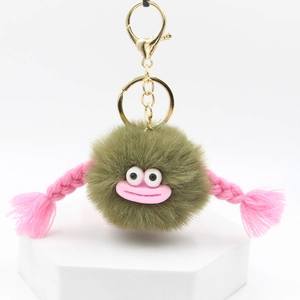 Detail of cute olive green plush keychain with funny pink lips and gold lobster clasp