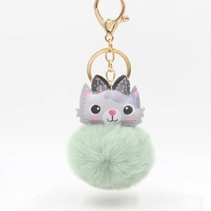 Mint green plush pom-pom keychain with cute cartoon cat charm and golden hardware