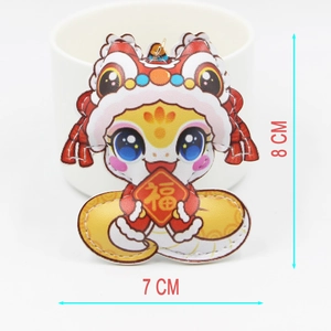 Detailed view of the 8cm snake keychain with lion dance hat and festive lucky red sign