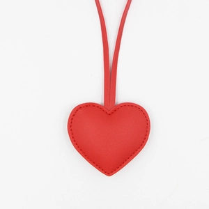 Red heart-shaped PU leather keychain pendant with detailed stitching on white background
