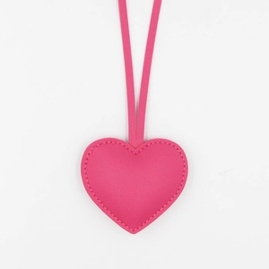 Pink heart-shaped PU leather keychain with matching strap and minimalist stitching design